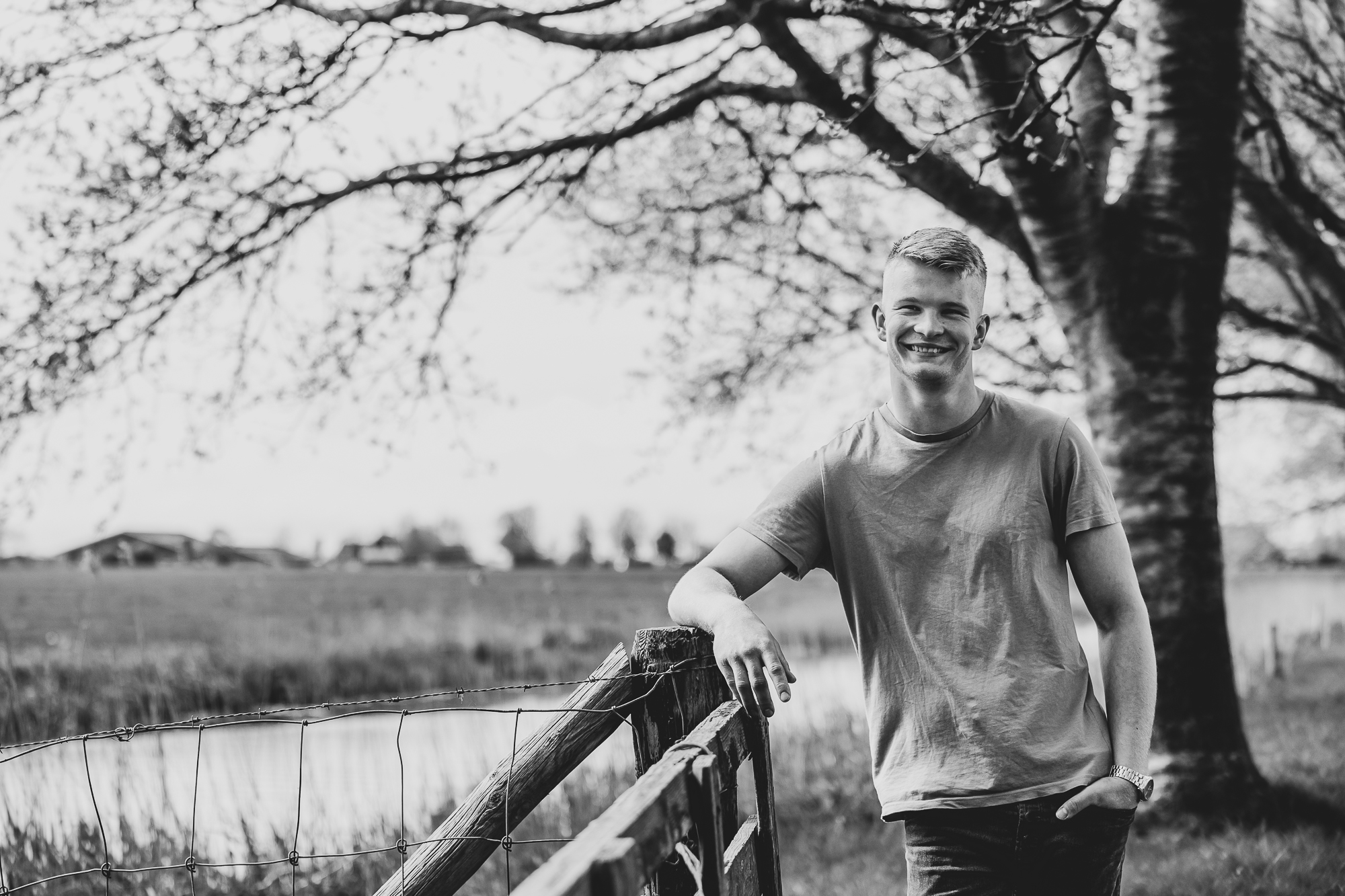 Zwart-wit portretfotografie bij houten hek in Friesland door portretfotograaf Nickie Fotografie uit Dokkum