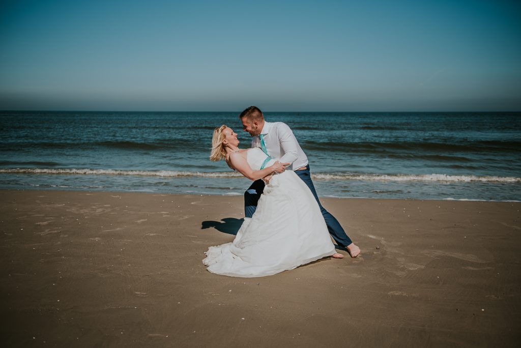 Fotoreportage in trouwkleding op het strand door fotograaf Nickie Fotografie uit Dokkum, Friesland.