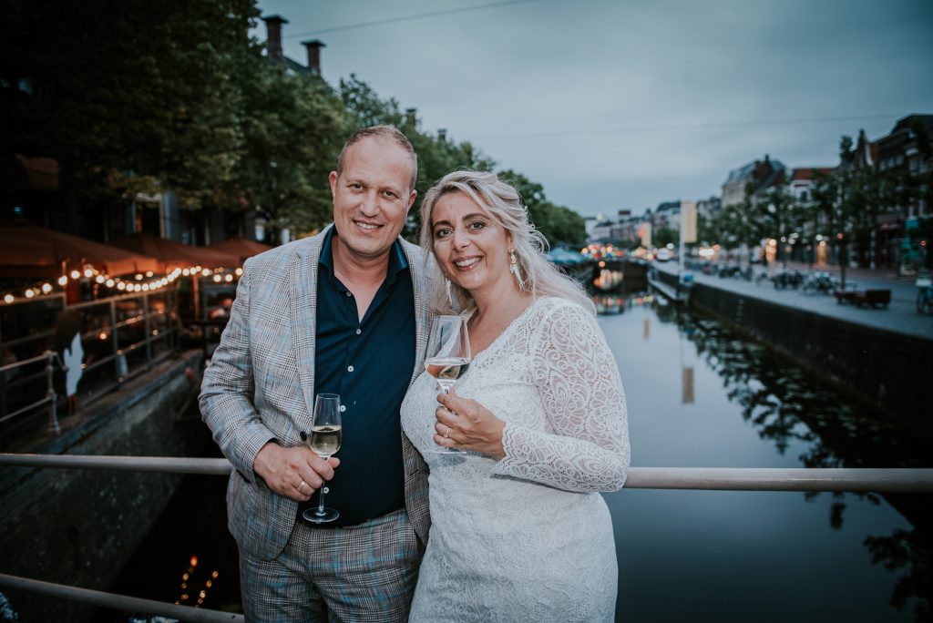 het bruidspaar op een bruggetje in het centrum van Leeuwarden. Huwelijksfotografie door huwelijksfotograaf Nickie Fotografie uit Dokkum, Friesland.