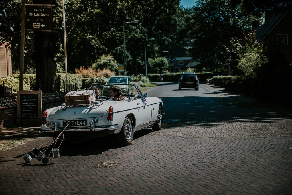Blikkjes achter de Bruidsauto MG cabrio met pas getrouwd blikjes. Huwelijksfotogrfie door huwelijksfotograaf Nickie Fotografie uit Dokkum, Friesland.