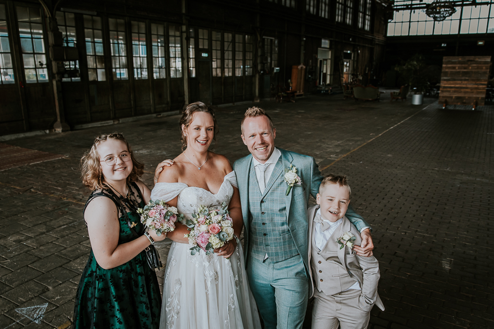 Bruidsshoot in de Sluisfabriek in Drachten. Gezinsportret in de grote fabriekshal door trouwfotograaf Nickie Fotografie uit Friesland.