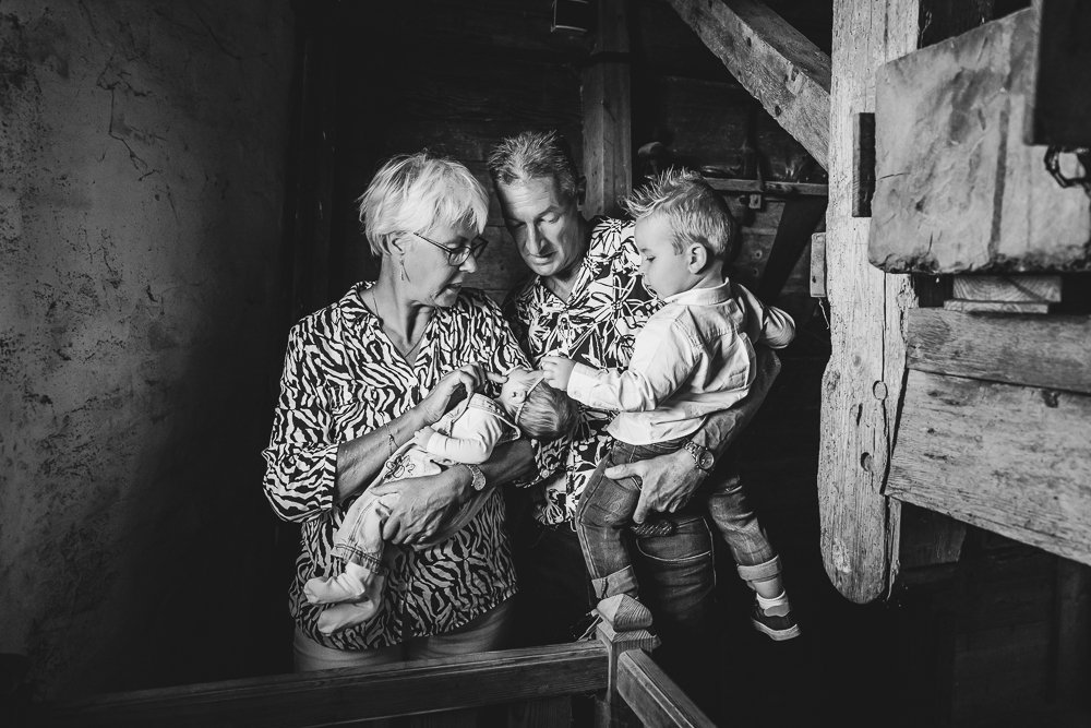 Familieshoot in molen Zeldenrust in Dokkum. Portret van opa en oma met hun kleinzoon en kleindochter. Zwart-wit shoot door fotograaf Nickie Fotografie uit Friesland.