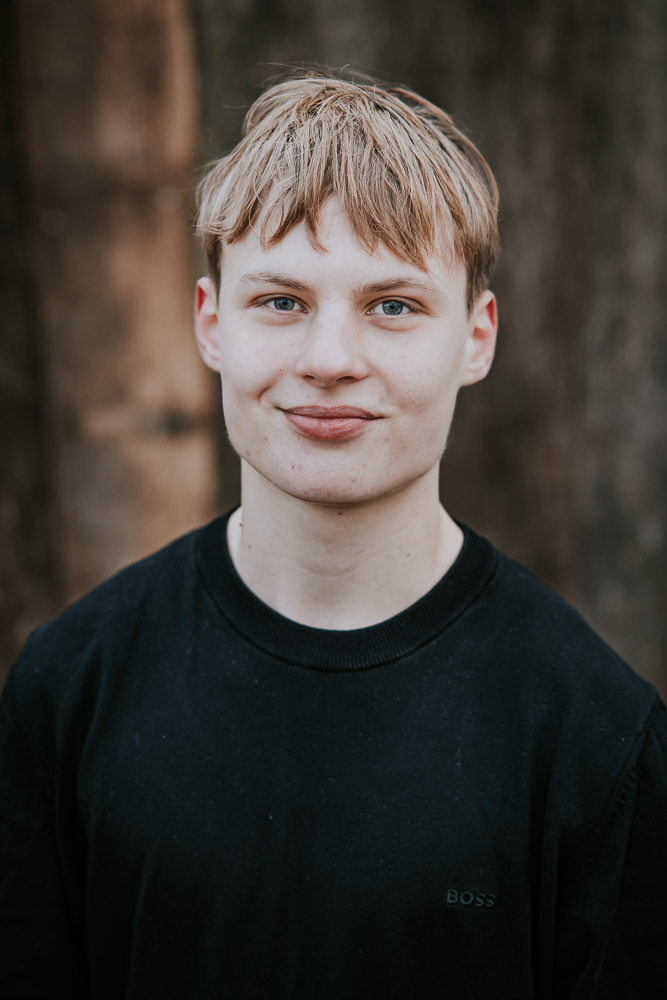 Portret van tienerjongen voor oude houten muur door fotograaf NIckie Fotografie uit Dokkum, Friesland.