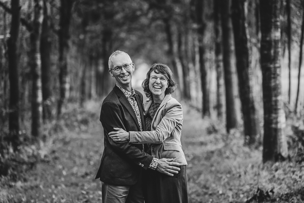Fotograaf Friesland. Enthousiaste zwart-wit portret van de ouders in prachtig laantje door Nickie Fotografie.